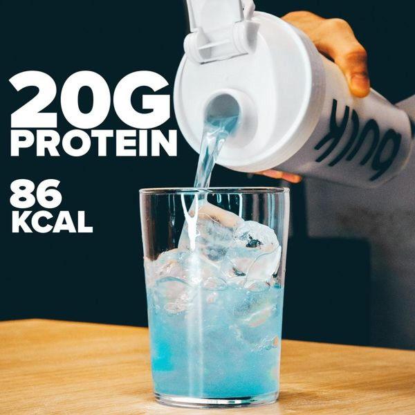 A close-up shot of a protein shake being poured into a glass, highlighting the precise protein content and low calorie count on the side of the frame.